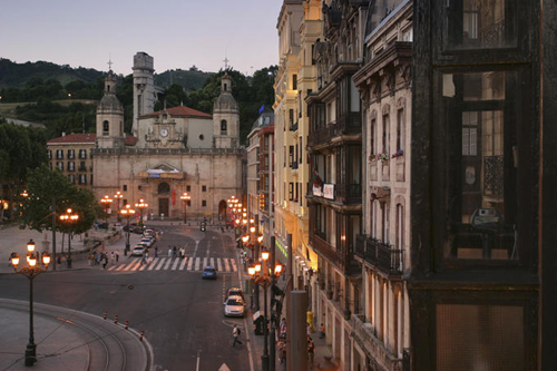 Streetlights, church and streetscape at sunset near Plaza Santiago.